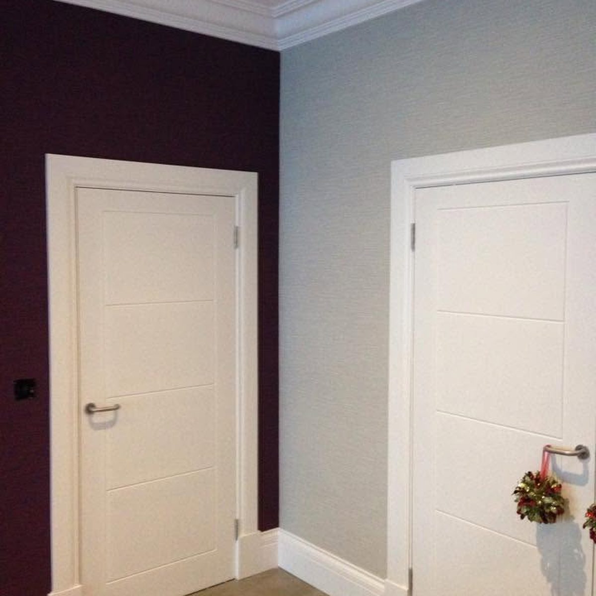 Aubergine feature wall with white doors, painted by Callaghan Decorators