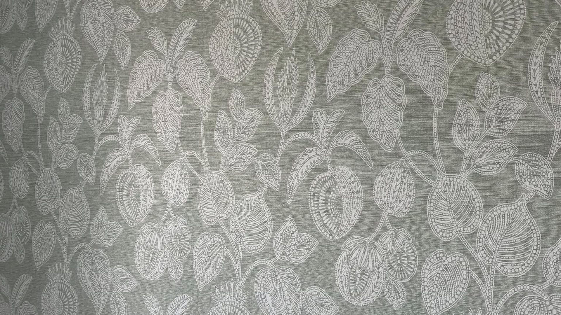 Sage green patterned wallpaper hung over white panelling by Callaghan Decorators, Ayr